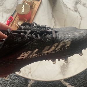 Blacked out with white outlines UA blur cleats